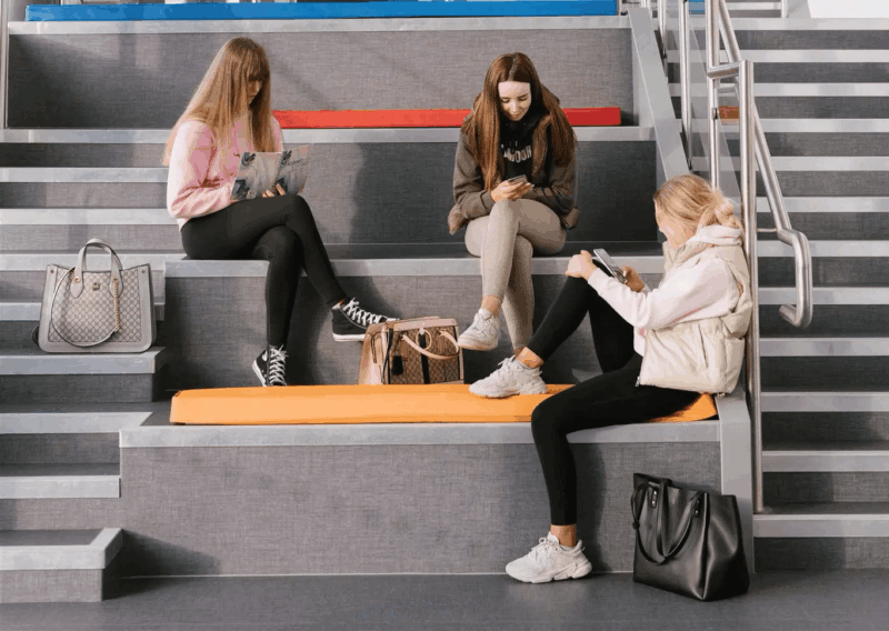 Students relaxing on colourful modern seating area in SWC campus