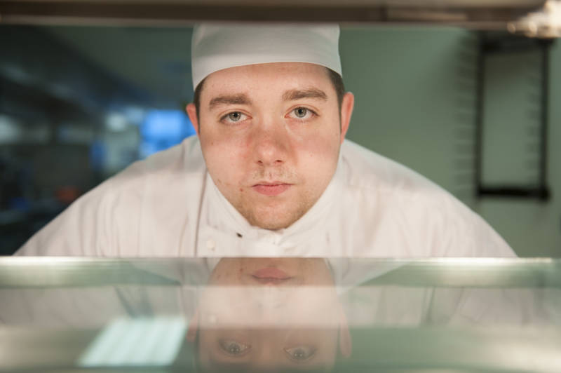 Student chef standing at pass